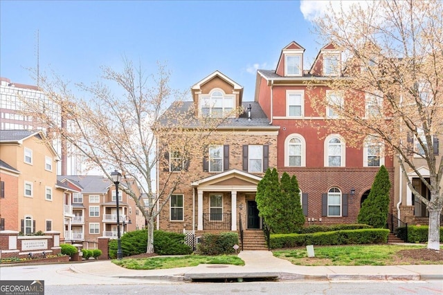 townhome / multi-family property with brick siding