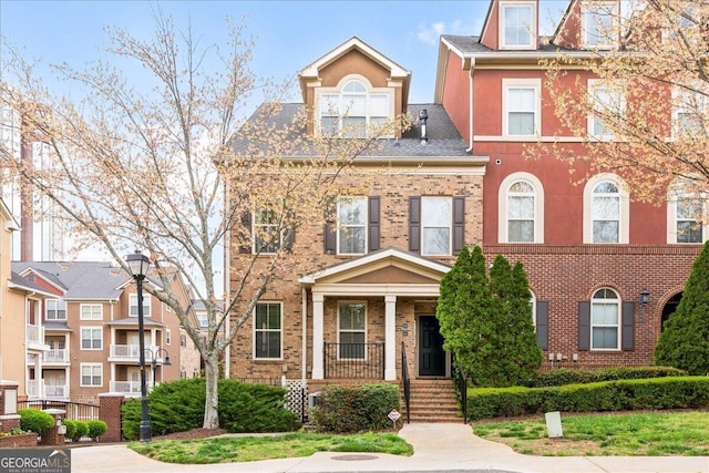 multi unit property with covered porch and brick siding