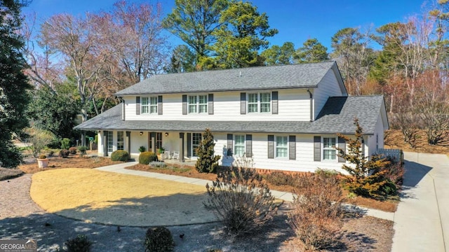 view of front of home with a shingled roof and covered porch