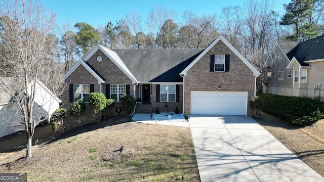 view of front of home with brick siding, an attached garage, and driveway