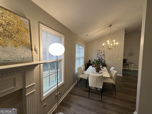 dining room with dark wood-style floors, lofted ceiling, a notable chandelier, and plenty of natural light