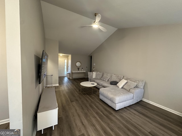 living area with a ceiling fan, dark wood-style flooring, vaulted ceiling, and baseboards