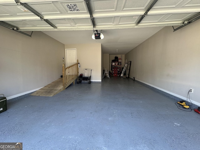 garage featuring a garage door opener and baseboards