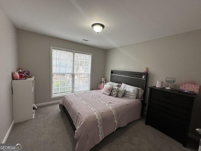 carpeted bedroom with visible vents and baseboards