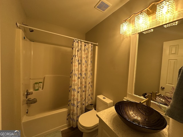 bathroom with visible vents, shower / tub combo with curtain, vanity, and toilet