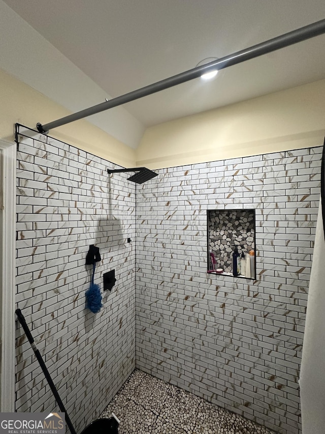 full bath featuring a tile shower