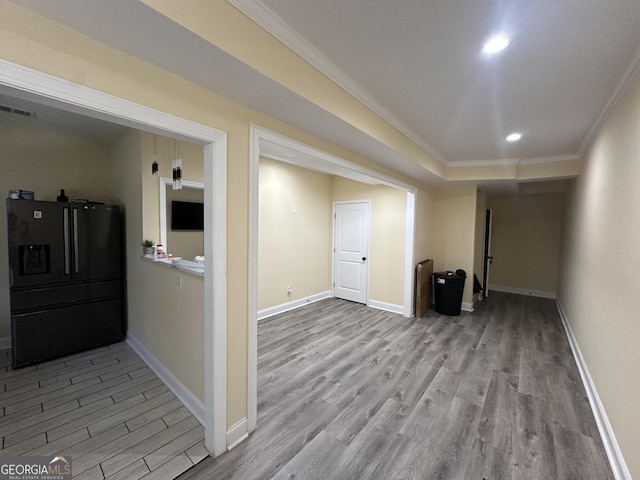 hall featuring recessed lighting, visible vents, ornamental molding, wood finished floors, and baseboards