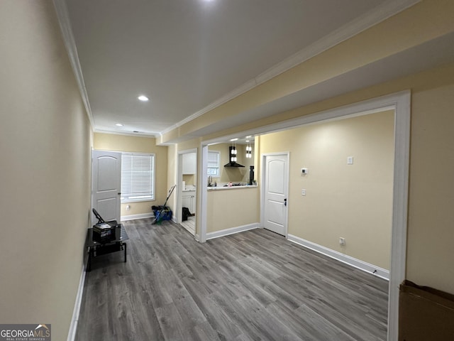 interior space featuring baseboards, dark wood-type flooring, recessed lighting, and crown molding