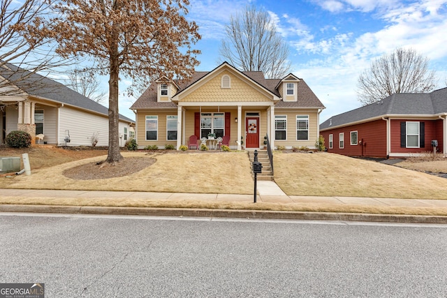 craftsman-style house featuring covered porch and a shingled roof