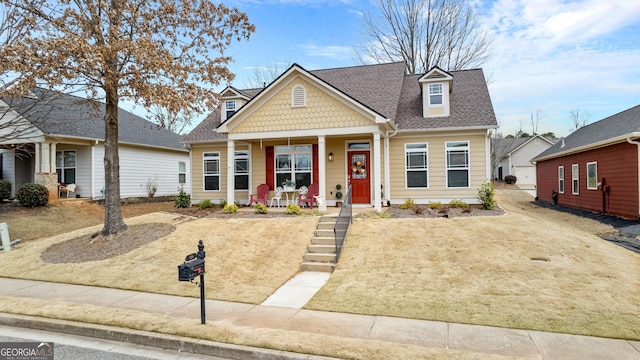 view of front of house with covered porch, driveway, and roof with shingles