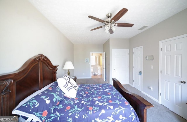 bedroom with carpet, visible vents, a textured ceiling, and baseboards