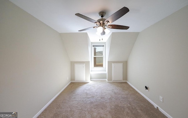 bonus room with carpet floors, baseboards, vaulted ceiling, and a ceiling fan