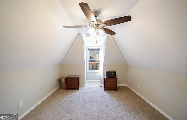 bonus room with a ceiling fan, carpet, lofted ceiling, and baseboards