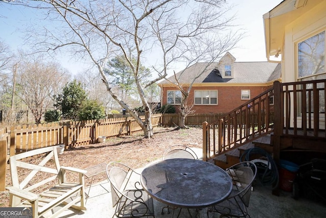 view of patio with outdoor dining area and fence