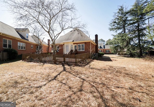 view of front of property featuring brick siding and fence