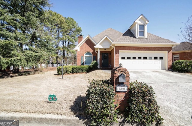 view of front of home featuring concrete driveway, brick siding, an attached garage, and roof with shingles