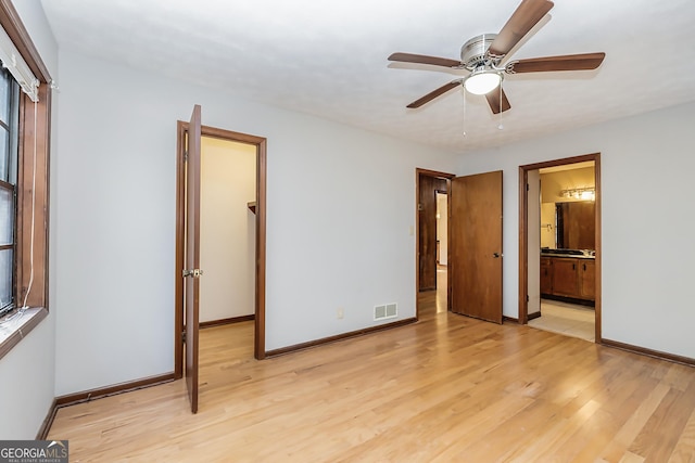 unfurnished bedroom featuring light wood-style floors, visible vents, and baseboards