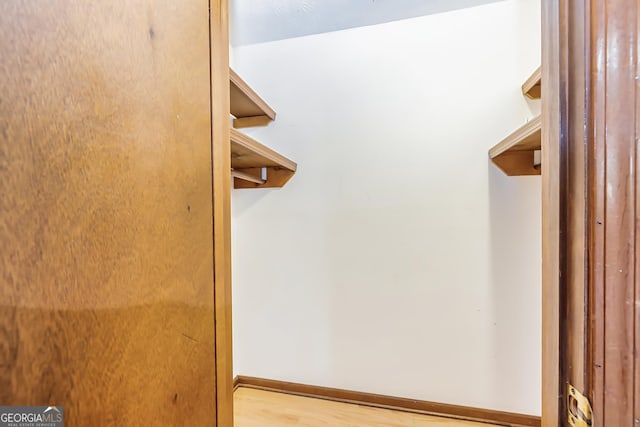 spacious closet featuring wood finished floors
