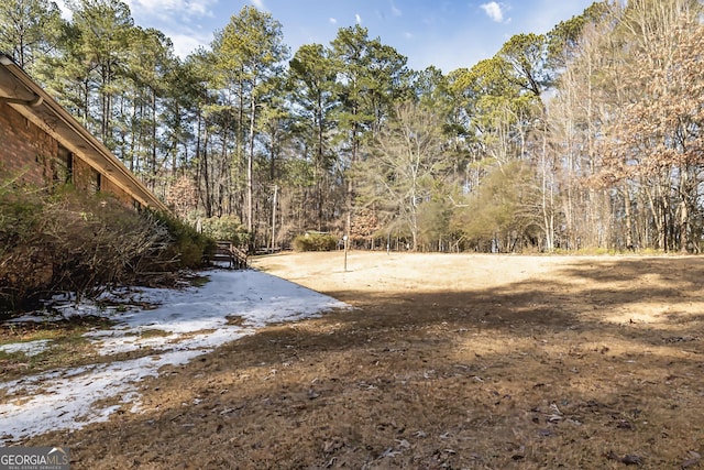 view of yard featuring a view of trees