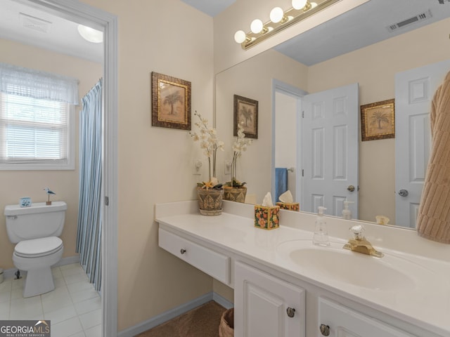 bathroom featuring visible vents, toilet, vanity, baseboards, and tile patterned floors