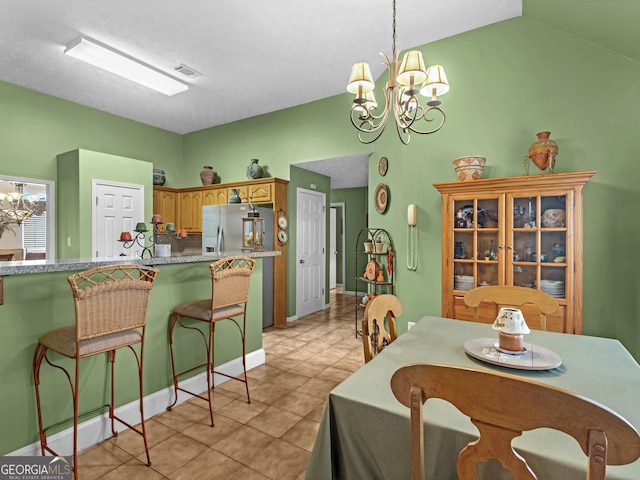 dining space featuring light tile patterned floors, visible vents, lofted ceiling, an inviting chandelier, and a textured ceiling