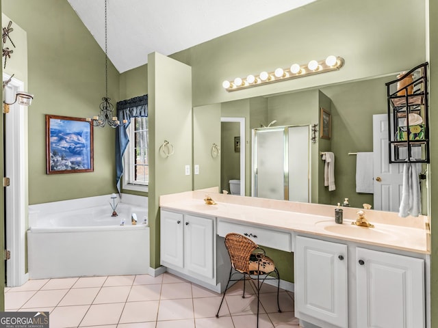 bathroom featuring tile patterned flooring, a sink, vaulted ceiling, double vanity, and a stall shower