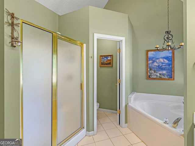 full bathroom featuring toilet, a shower stall, a bath, and tile patterned floors