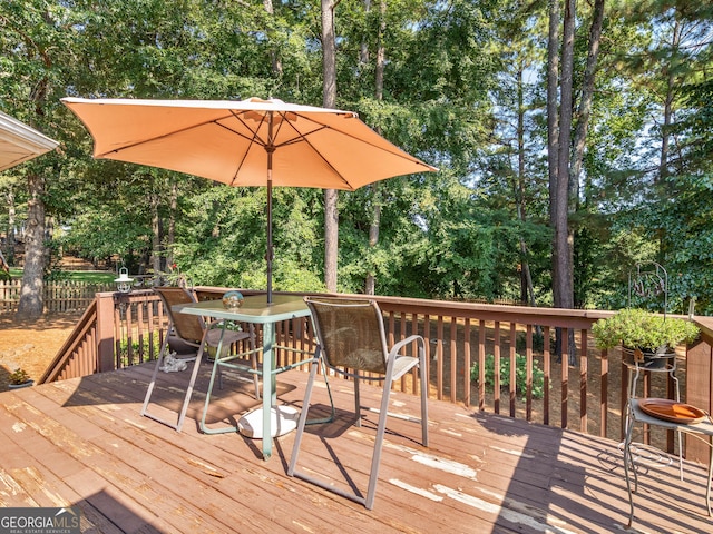 wooden terrace with outdoor dining space