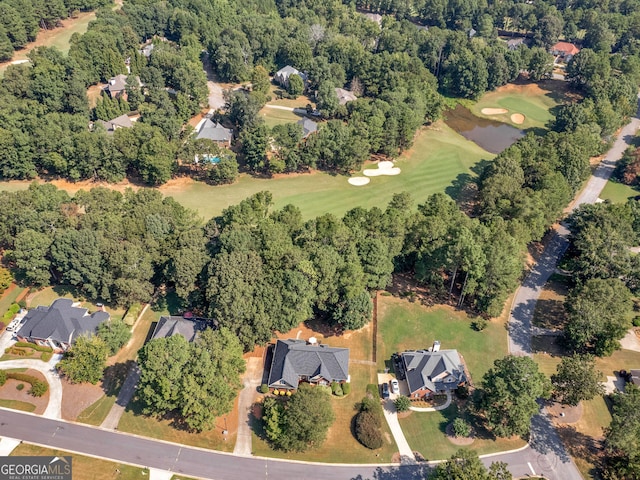 aerial view featuring view of golf course and a view of trees