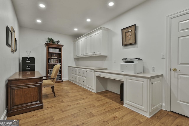 office space with baseboards, recessed lighting, built in study area, and light wood-style floors