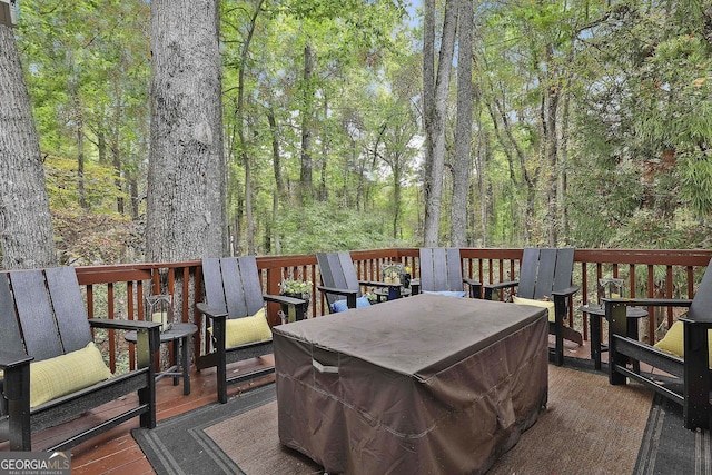 wooden terrace featuring a view of trees