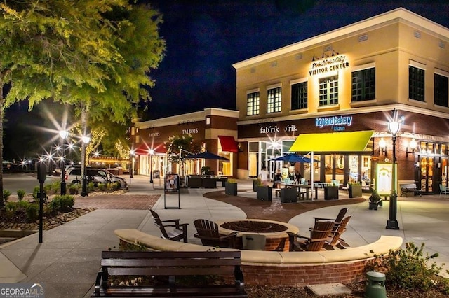 property at night with an outdoor fire pit