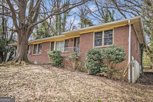 ranch-style house featuring brick siding