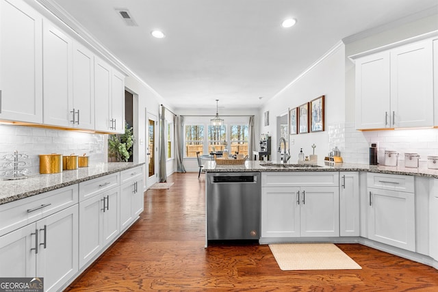 kitchen with stainless steel dishwasher, ornamental molding, white cabinetry, a sink, and a peninsula