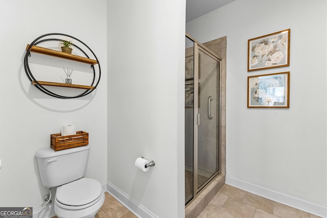 full bathroom with baseboards, a shower stall, and toilet