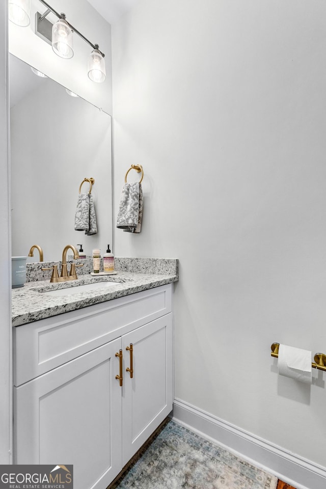 bathroom with baseboards and vanity