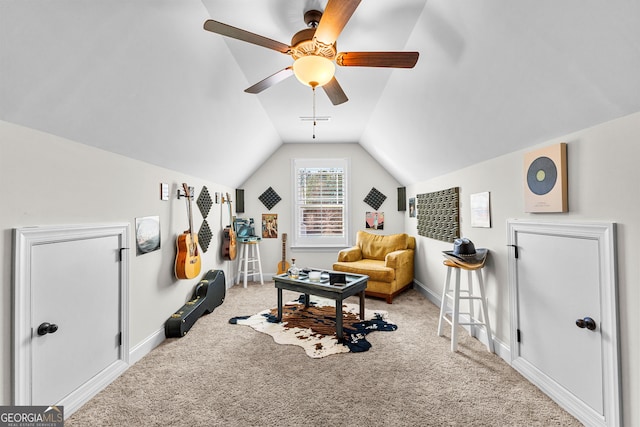 exercise area with lofted ceiling, visible vents, a ceiling fan, carpet flooring, and baseboards