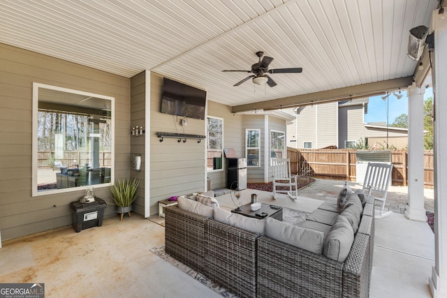 view of patio / terrace with a ceiling fan, fence, and an outdoor living space