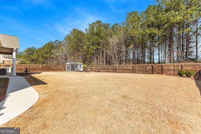 view of yard with a fenced backyard and an outdoor structure