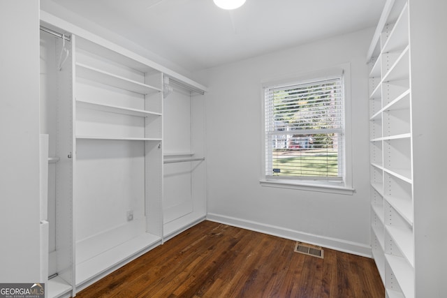 walk in closet with dark wood-style floors and visible vents