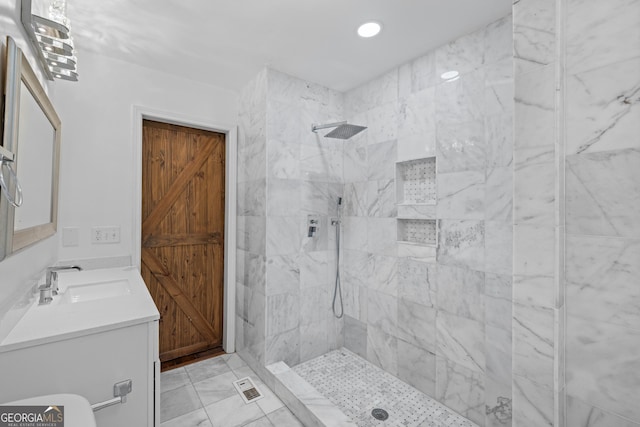 full bathroom featuring visible vents, tiled shower, vanity, and recessed lighting