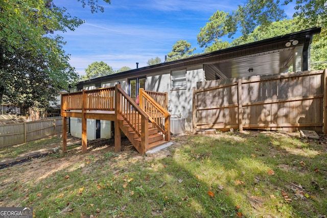 exterior space with stairs, fence, a wooden deck, and central air condition unit