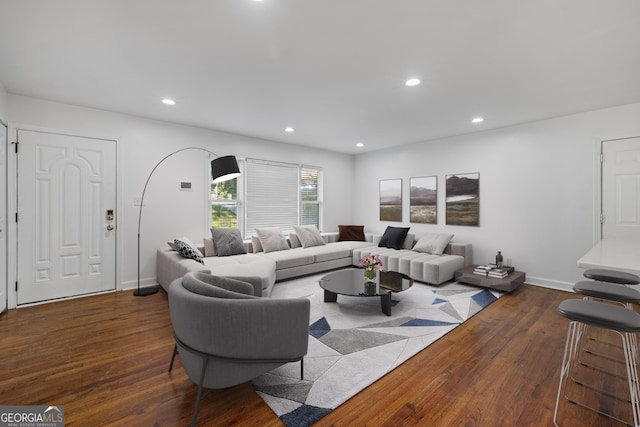 living room featuring recessed lighting, baseboards, and hardwood / wood-style floors