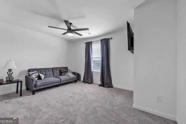 carpeted living room with ceiling fan and baseboards