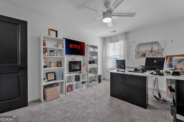 office with a ceiling fan, visible vents, and carpet flooring