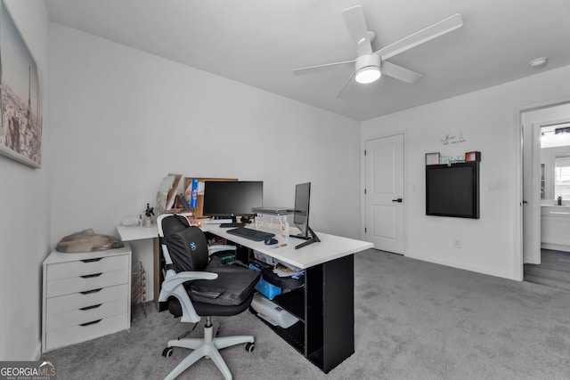 carpeted office with ceiling fan