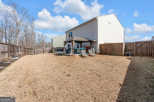 back of house with a gazebo, a patio, and a fenced backyard