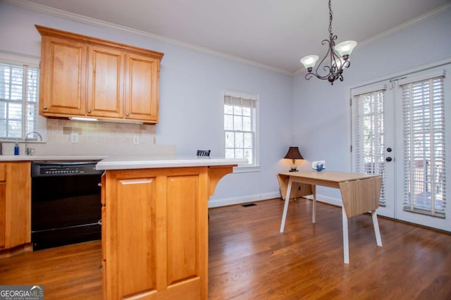 kitchen featuring black dishwasher, a peninsula, ornamental molding, and wood finished floors