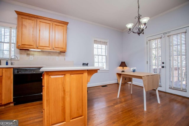 kitchen with a peninsula, black dishwasher, crown molding, and wood finished floors