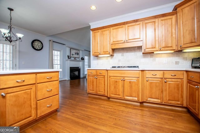 kitchen with light countertops, light wood finished floors, plenty of natural light, and backsplash